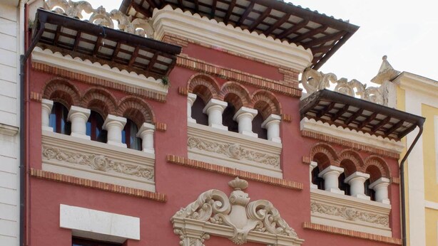 A building with ornate architectural details, including multiple balconies with arches and decorative moldings. - L'Àgora Hotel (Bocairente)