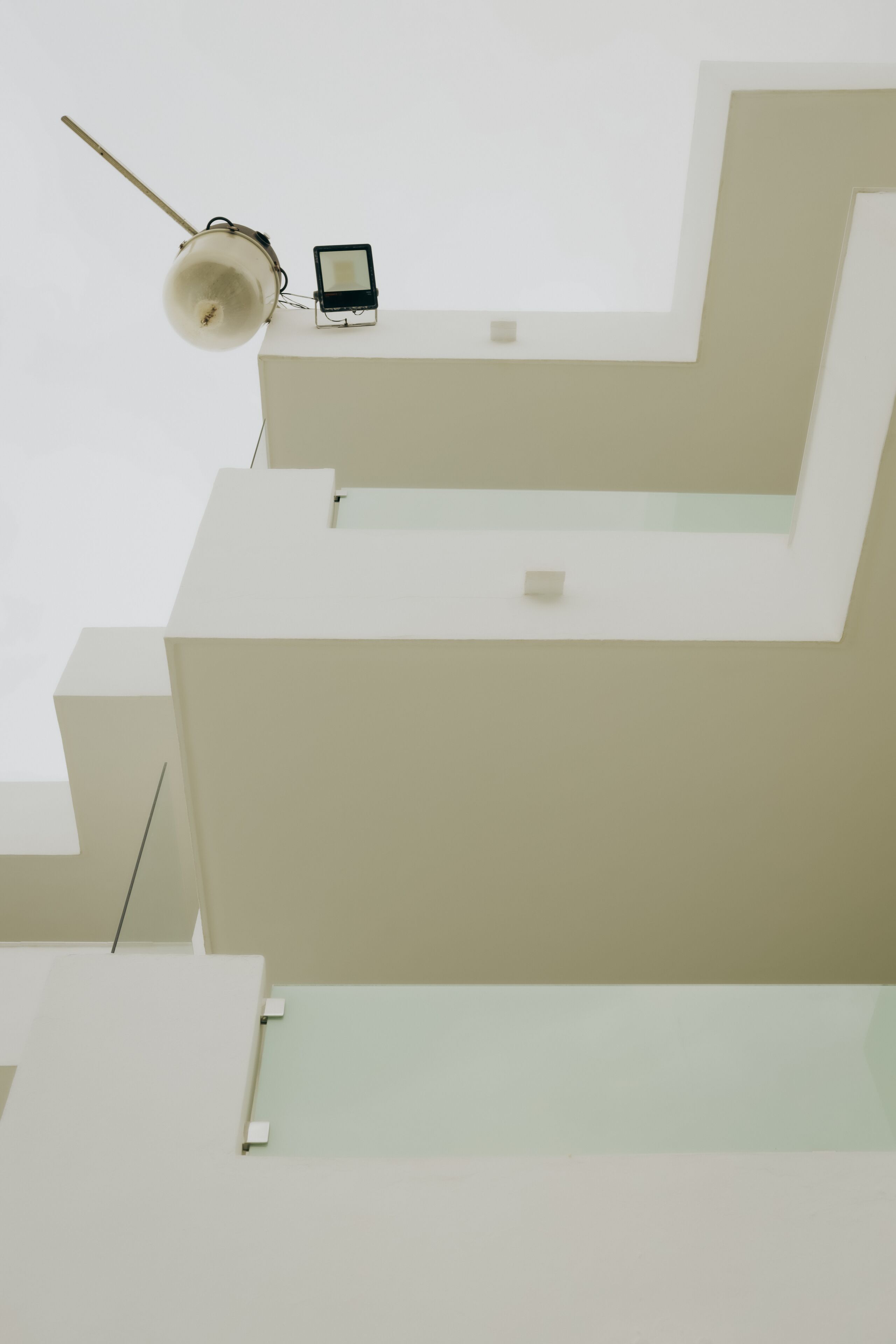 A modern building with a minimalist design, featuring geometric shapes and a flat roof.