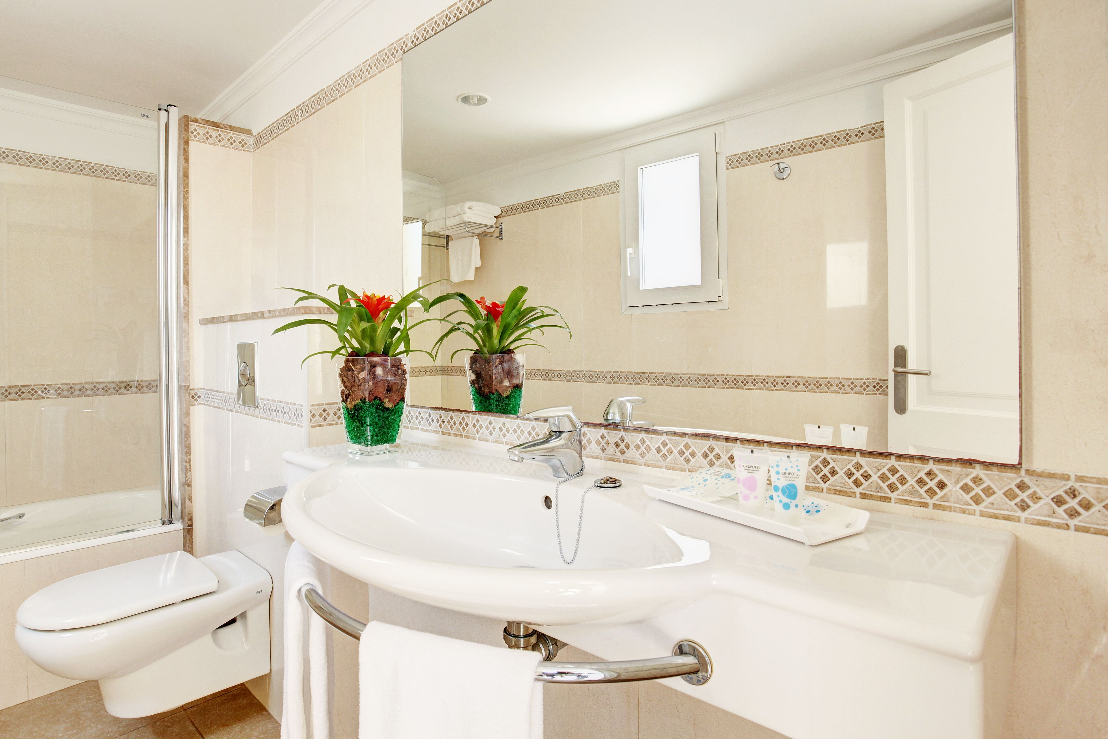 deep-soaking bathtub, designer toiletries, hair dryer, towels