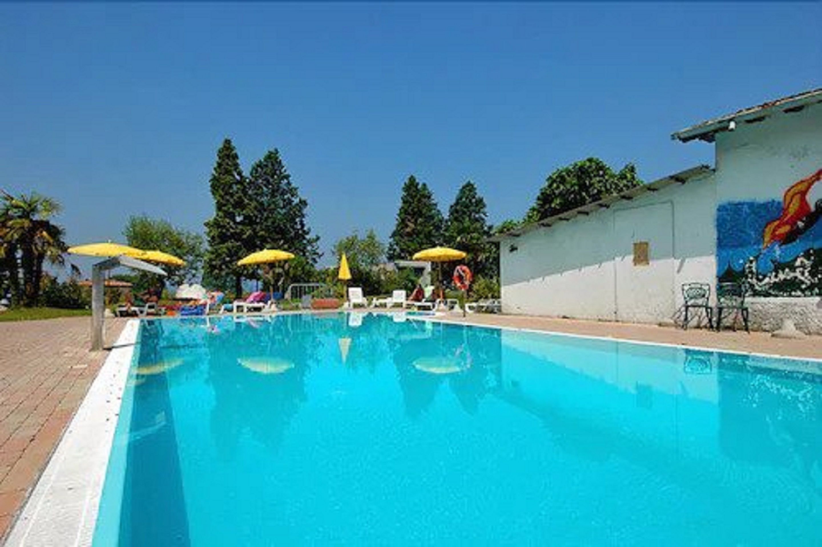 outdoor pool, open 9 am to 7 pm, pool umbrellas, pool loungers
