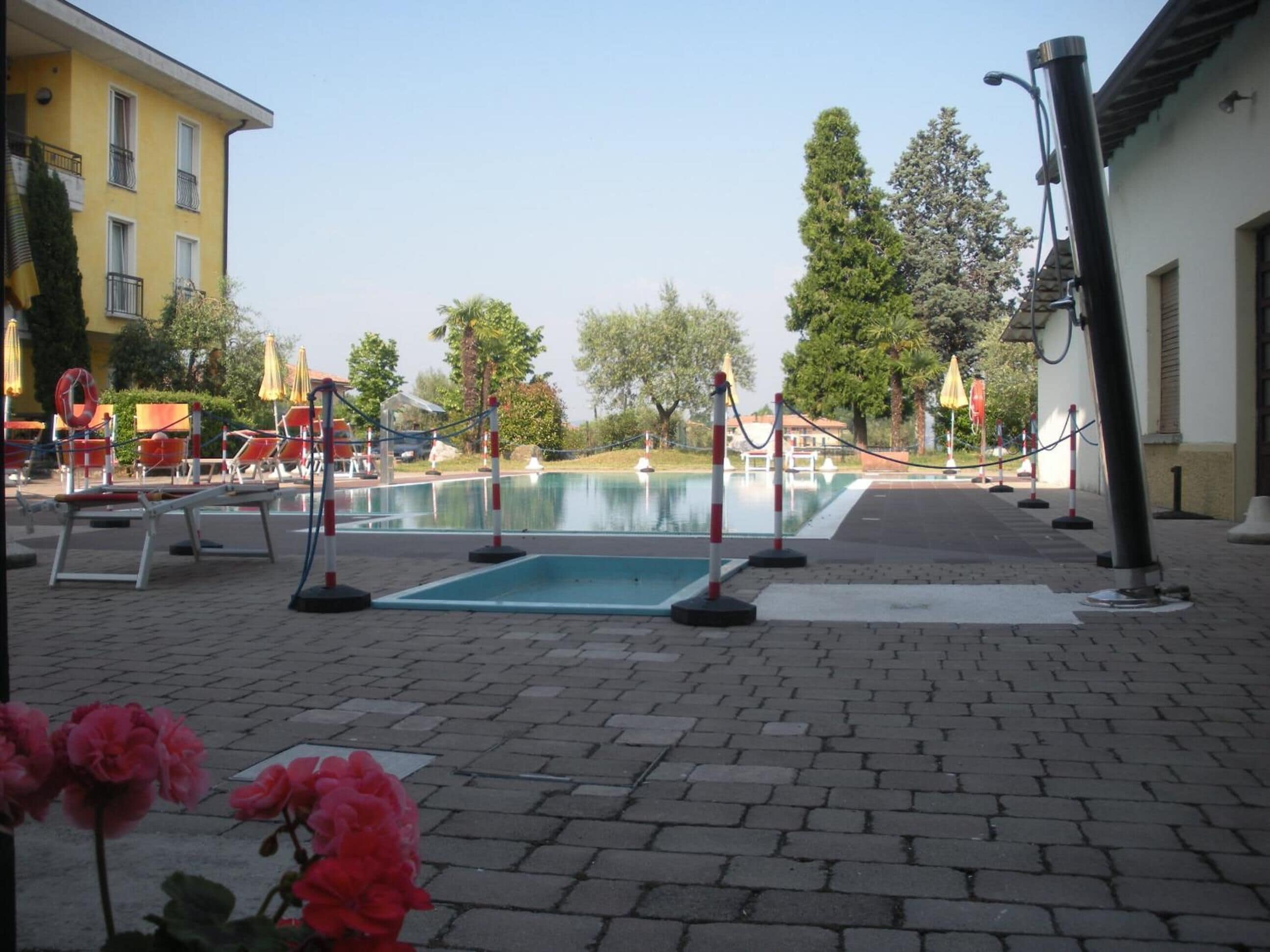 Outdoor pool, open 9 AM to 7 PM, pool umbrellas, pool loungers