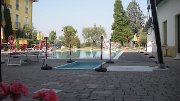 Outdoor pool, open 9 AM to 7 PM, pool umbrellas, pool loungers