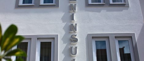 A building with the name 'PENINSULA' prominently displayed on its facade.