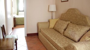 A living room with a beige sofa, a lamp, and a framed picture on the wall. - B&B A Florence View (Florence)