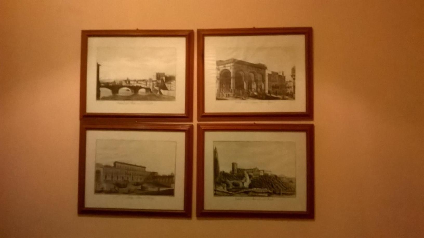 Four framed black and white photographs on a wall.