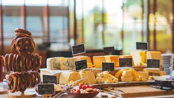 A cheese and pretzel display with various types of cheese and pretzels.