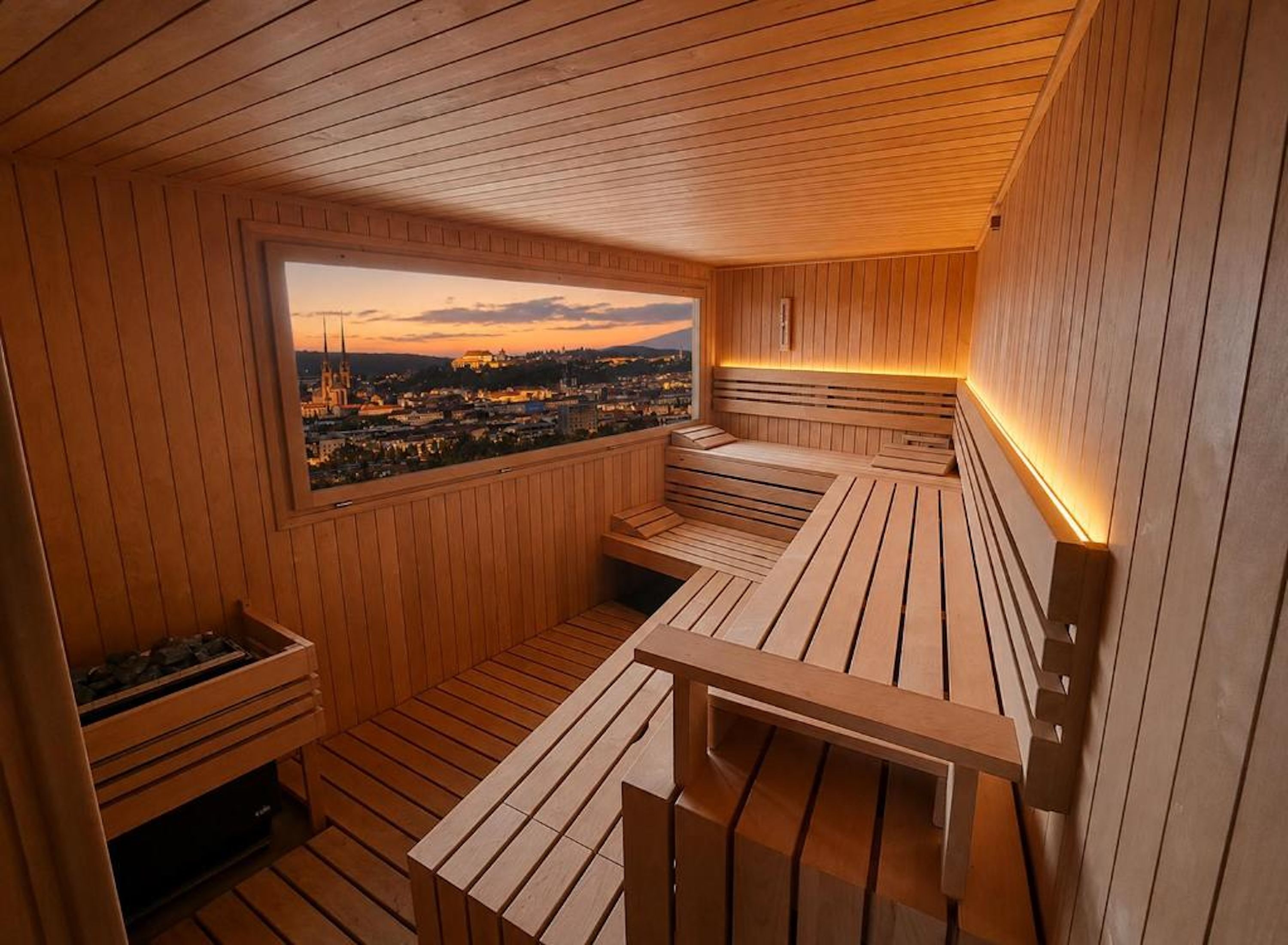 A sauna room with wooden benches and a view of a cityscape.