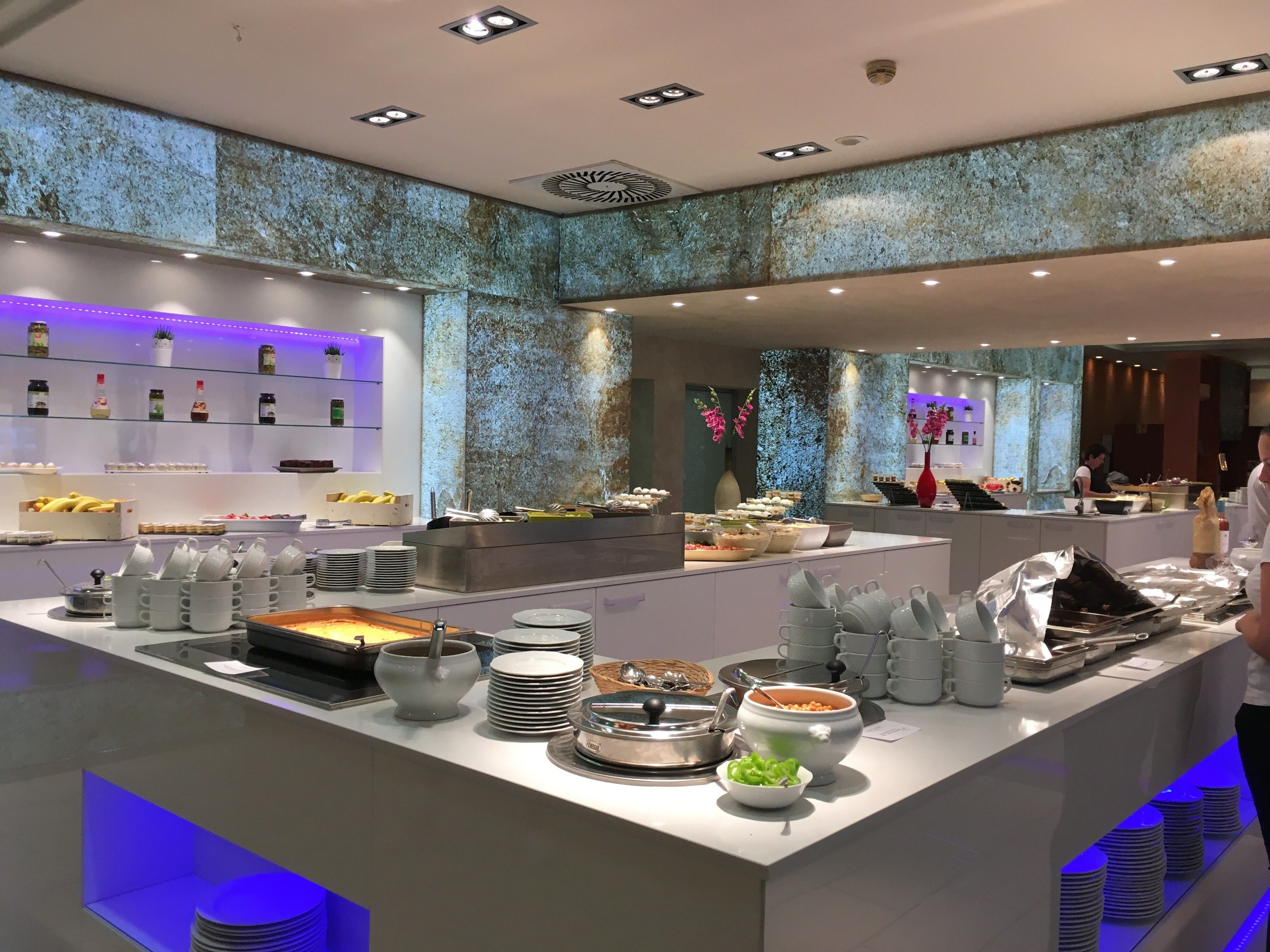 A buffet area with various food items and utensils.