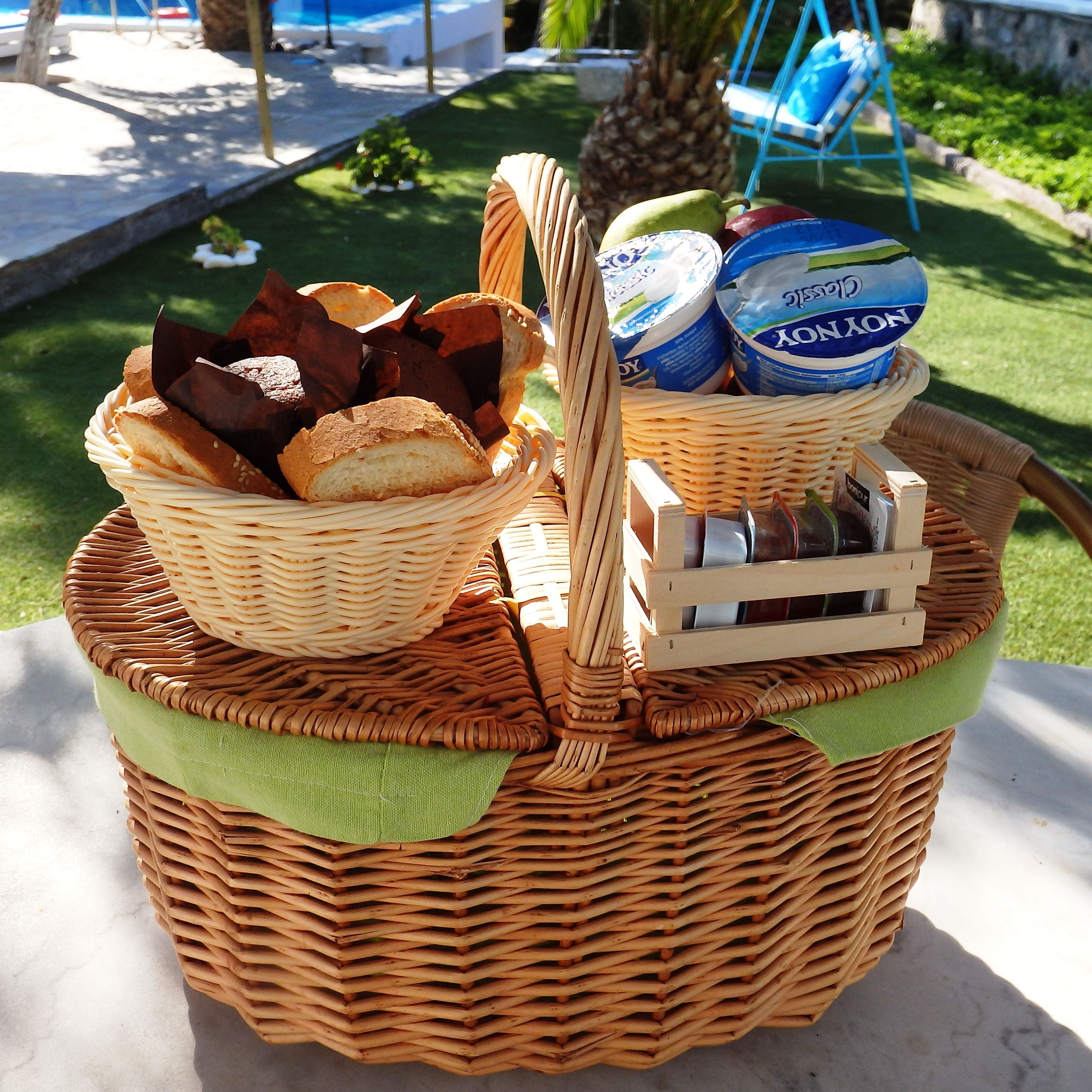 A wicker basket with bread and dairy products.