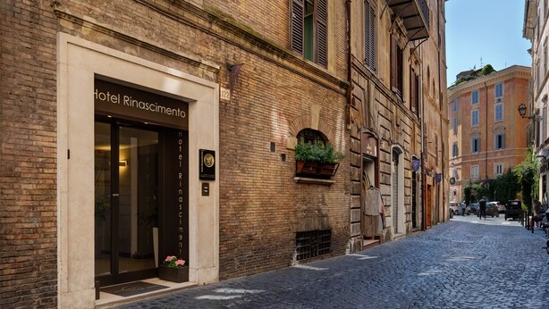 A cobblestone street with a hotel entrance labeled "Hotel Rinascimento." - Hotel Rinascimento  (Rome)