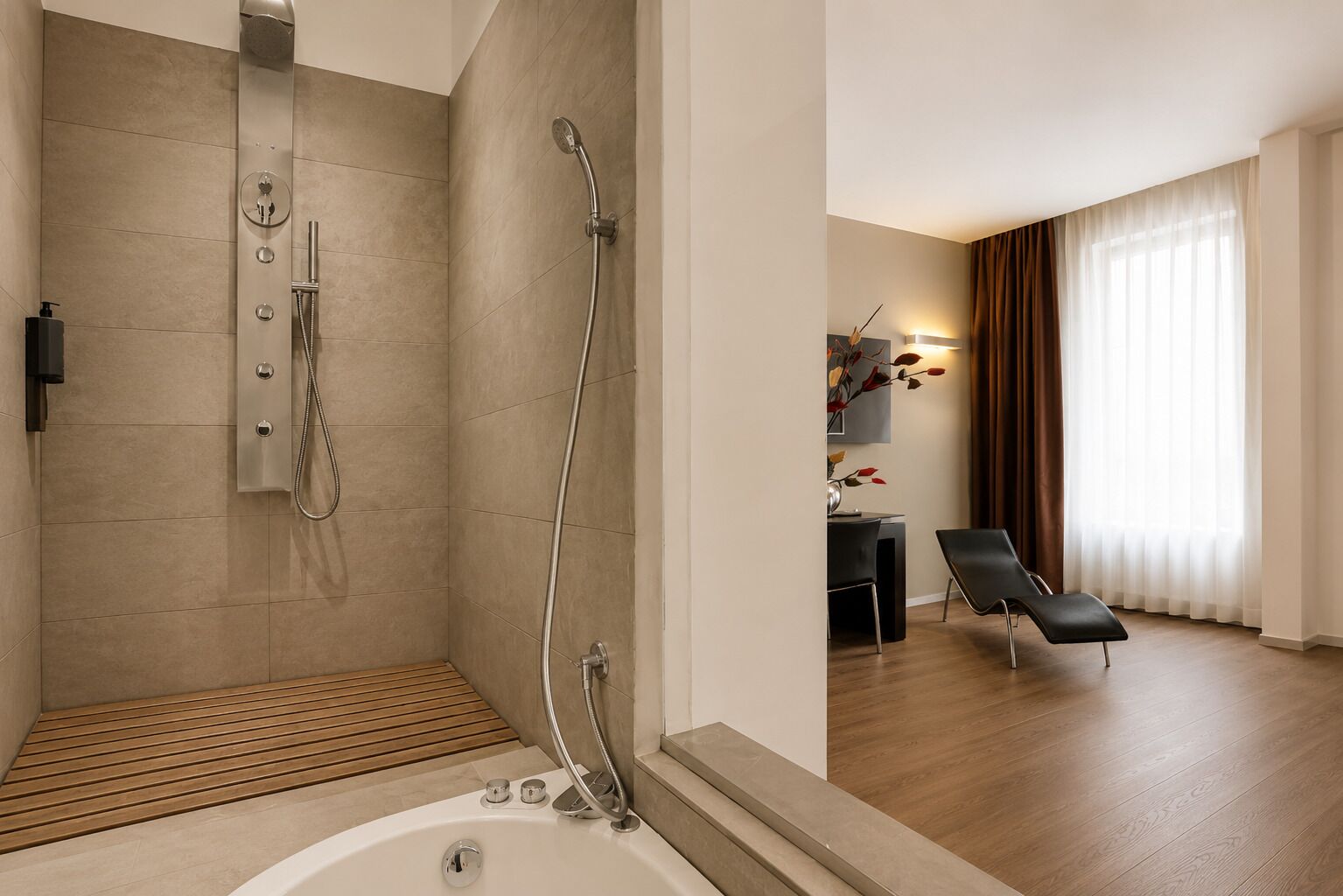 A modern bathroom with a shower, a bathtub, and a wooden floor.
