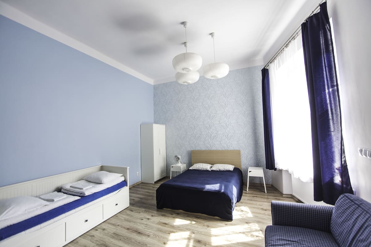 A modern bedroom with a bed, bedside table, and a chair.