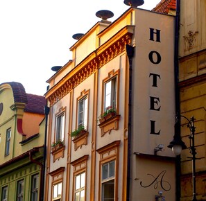 A building with a sign reading "HOTEL" and a decorative lamp post. - Hotel Antik (Prague)