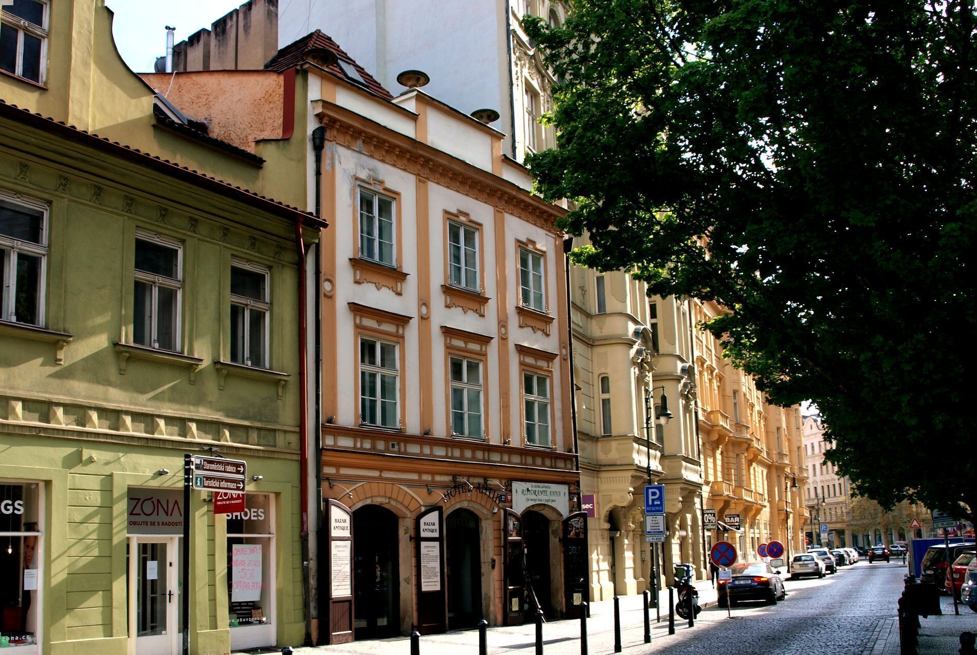 A row of historic buildings with storefronts, including a shoe store and an antique shop.