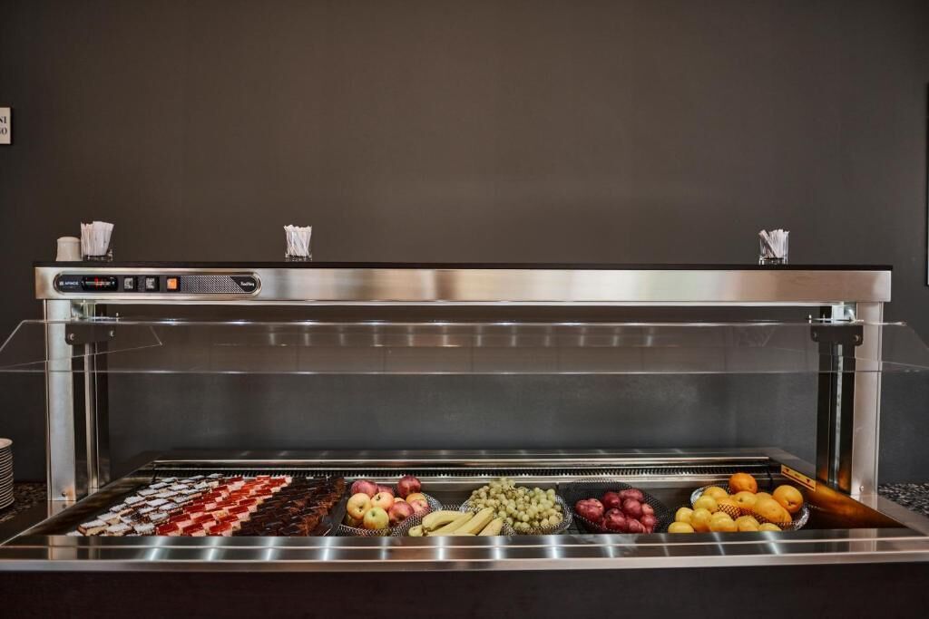 A self-service food display with various fruits and snacks.
