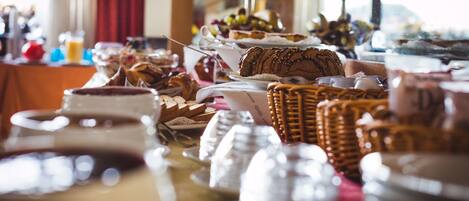 A buffet table with various food items and dishes.
