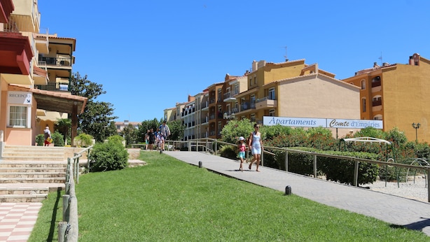 A pathway leading to a building with a sign for 'Apartments' and 'Conte d'Empuries'. - Apartaments Comte d'Empuries (Castello d'Empuries)