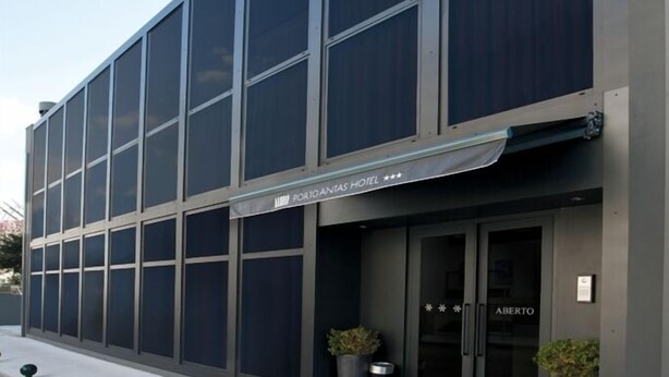 A modern building with large windows and a sign that reads "PORTLAND PARK HOTEL". -  Stay Hotel Porto Centro Antas (Porto)