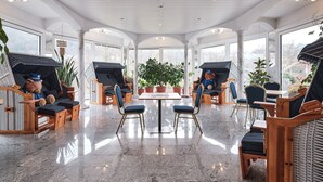 A spacious room with a high ceiling, large windows, and a central table surrounded by chairs. - Hotel am Hochrhein (Bad Saeckingen)