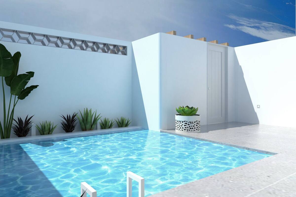 A modern indoor pool with geometric wall designs and various plants.