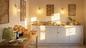 A kitchen with a central island, wooden cabinets, and a breakfast bar.