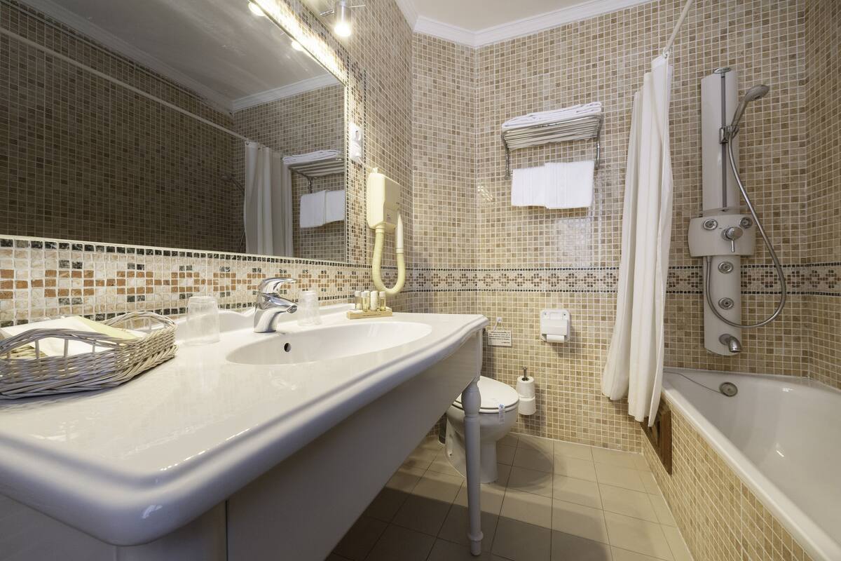 superior room | bathroom | deep-soaking bathtub, hair dryer, towels