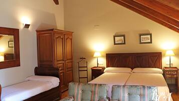 A bedroom with a large bed, two bedside tables with lamps, a wardrobe, and a chair.