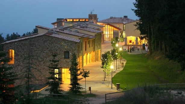 A stone building with a large entrance and a well-lit pathway leading to a grassy area. - Vilar Rural de Sant Hilari by Serhs Hotels (Sant Hilari Sacalm)