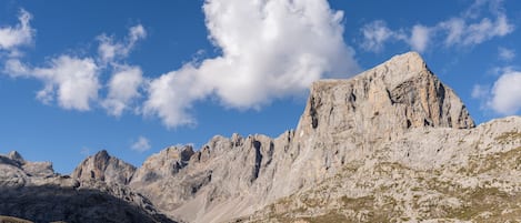 A mountainous landscape with rocky terrain and a prominent peak.