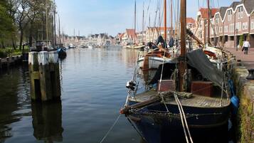A canal with boats docked along the sides, surrounded by traditional buildings.