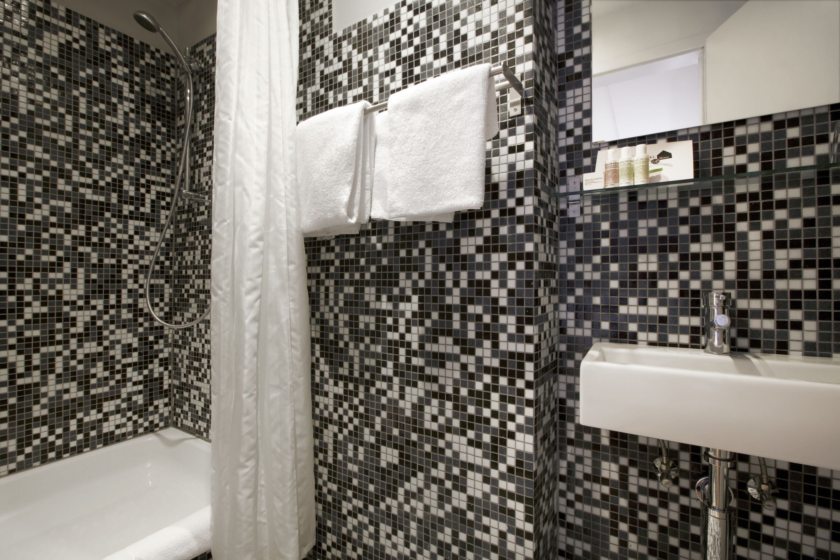 designer toiletries, hair dryer, towels