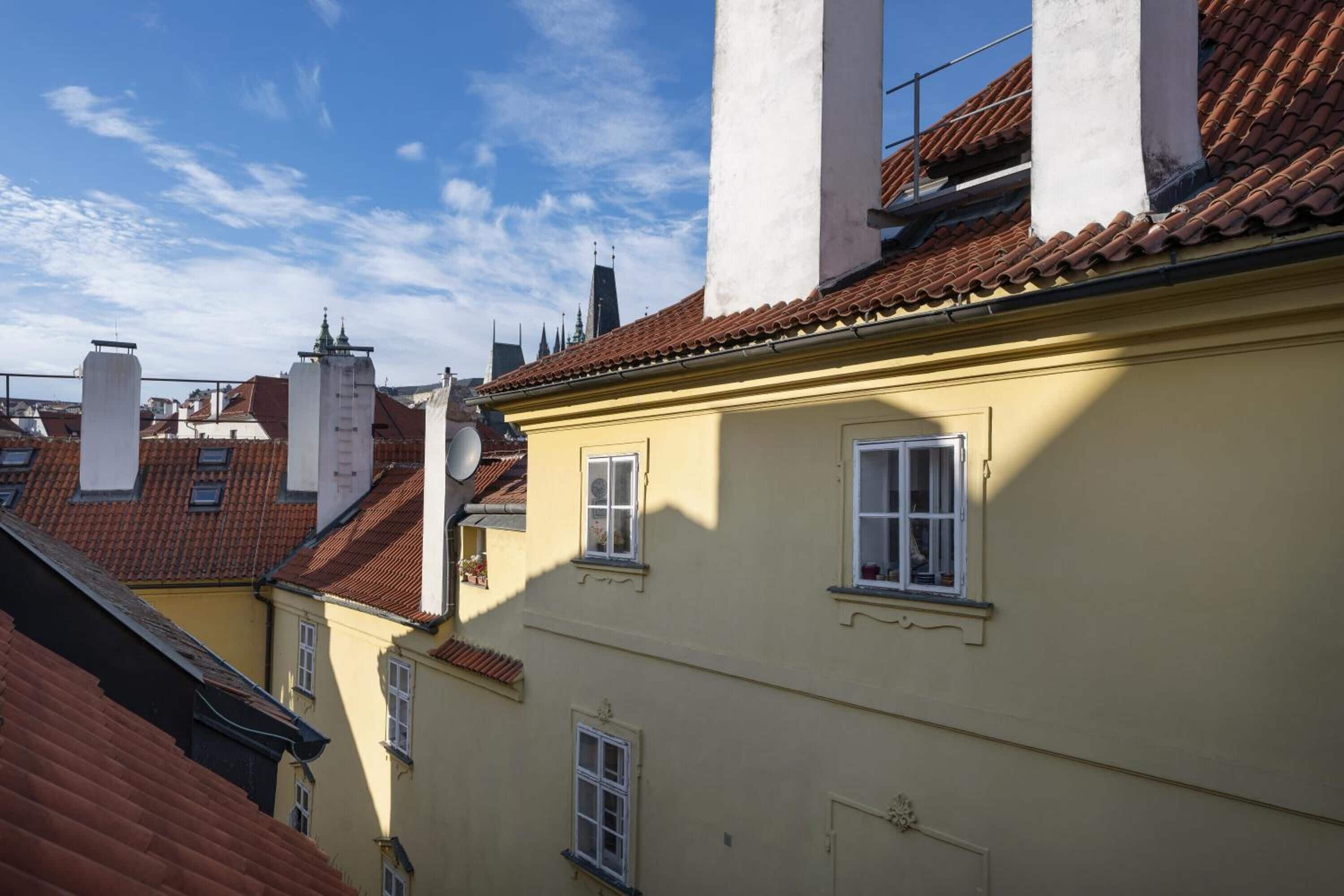 A building with multiple windows and a red-tiled roof.