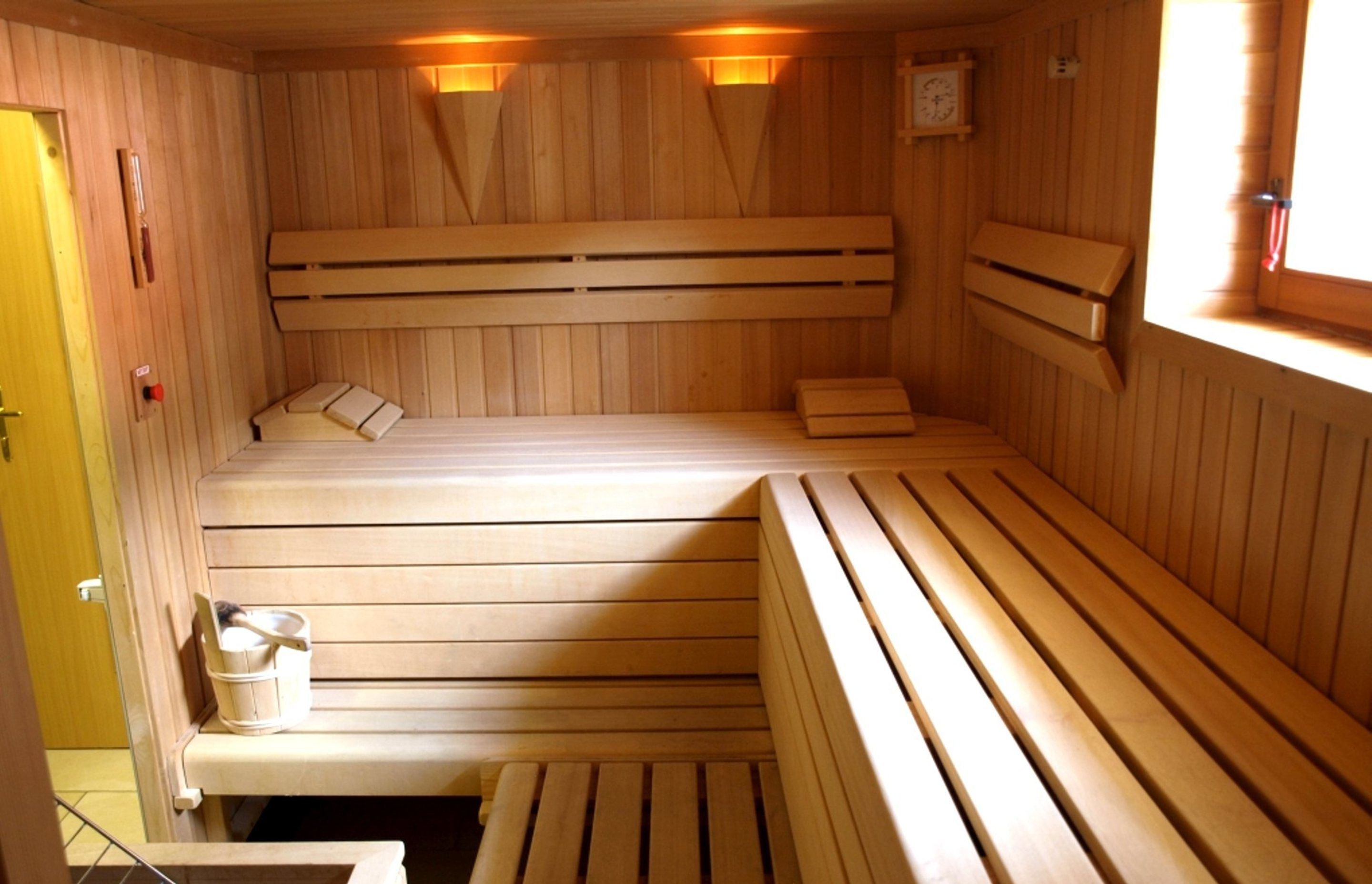 A wooden sauna with benches and benches on the sides.