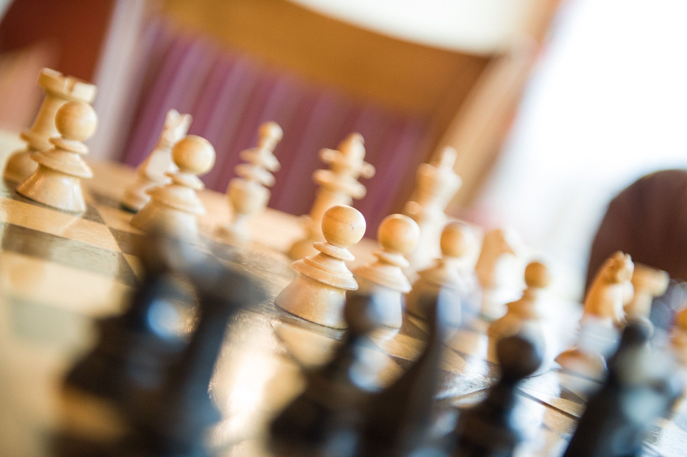 A close-up of a chessboard with pieces in focus.