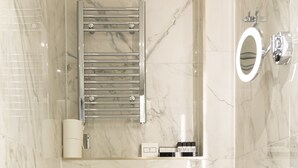 A modern bathroom with a toilet, bidet, and a mirror.