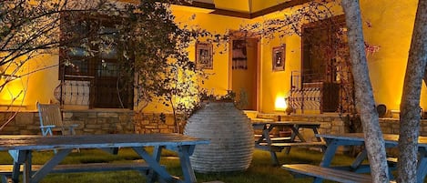 A courtyard with outdoor seating and a large stone planter.