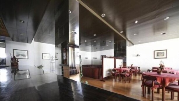 A modern dining area with a polished floor, wooden tables, and chairs. - Hotel Palanca (Porto)