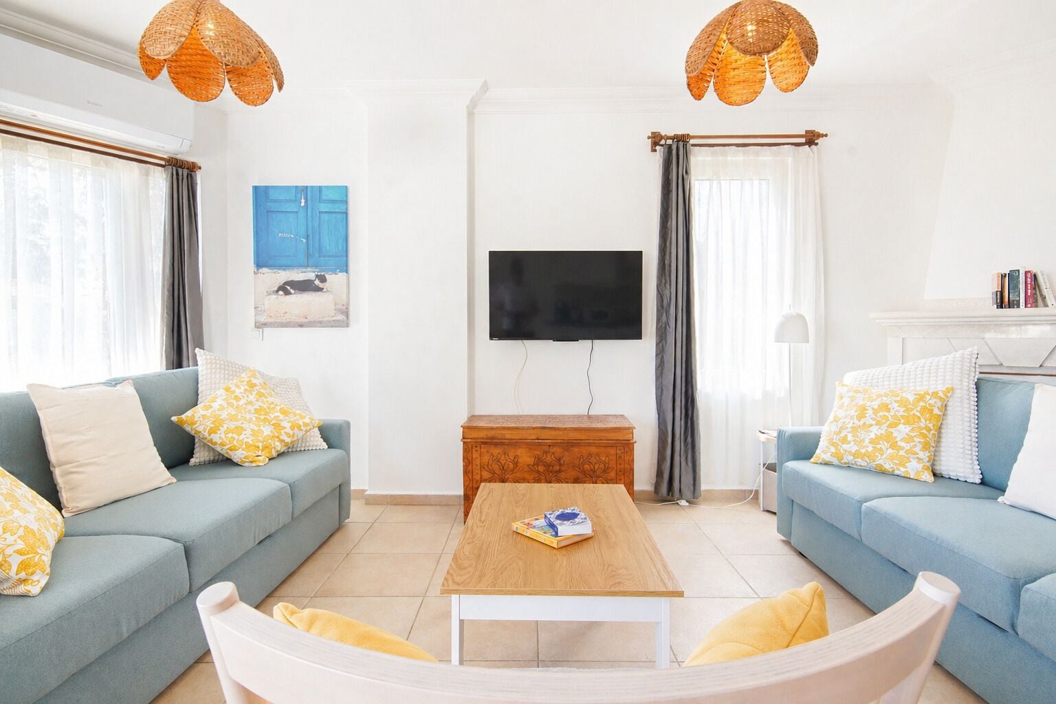 A living room with two sofas, a coffee table, a TV, and a fireplace.