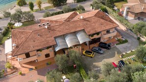 Una villa de estilo mediterráneo con tejado de baldosas, un porche cubierto y vistas al mar.