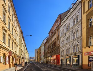 A street view with buildings on both sides, including a hotel with a sign that reads "HOTEL". - Hotel Residence Tabor (Prague)