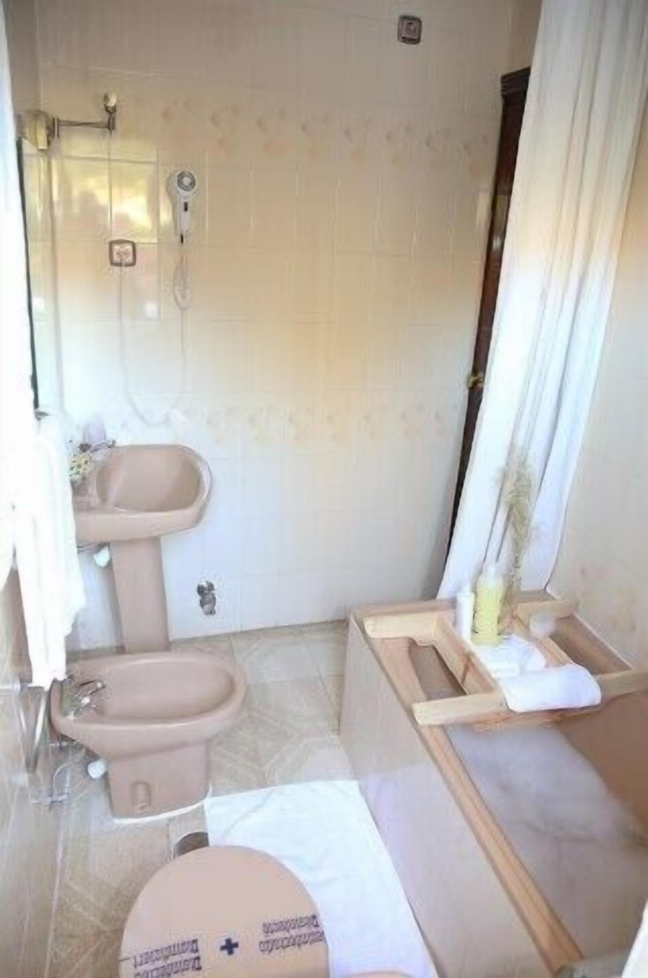 bathtub, designer toiletries, hair dryer, bidet