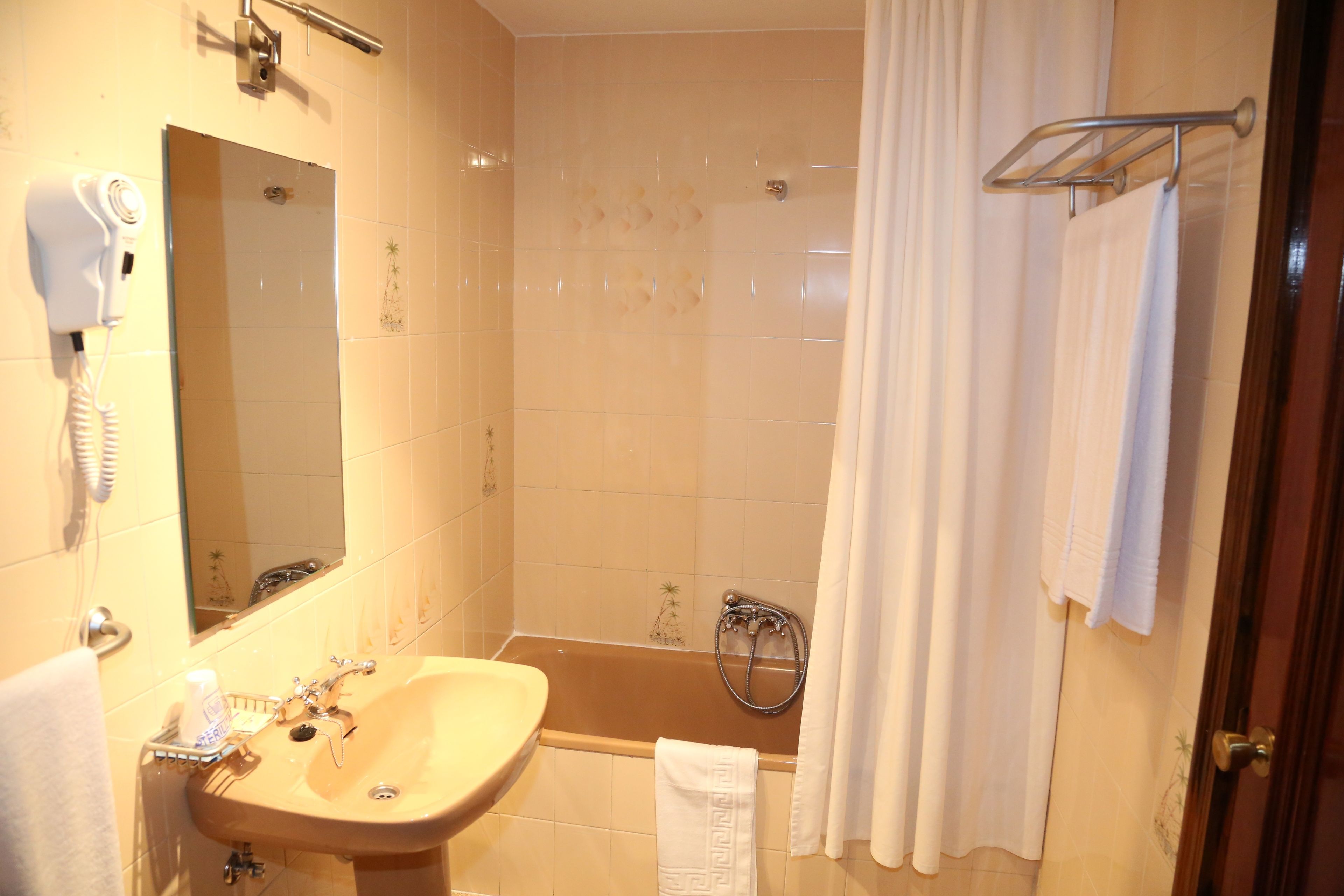 bathtub, designer toiletries, hair dryer, bidet