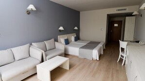 A modern hotel room with a sofa, two beds, a small table, and a desk. - Resort Bella Vista Beach Club (Sinemoretz)