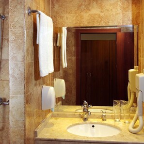 A bathroom with a sink, mirror, towel rack, and a wooden door. - Bella Vista Beach Club (Tsarevo)