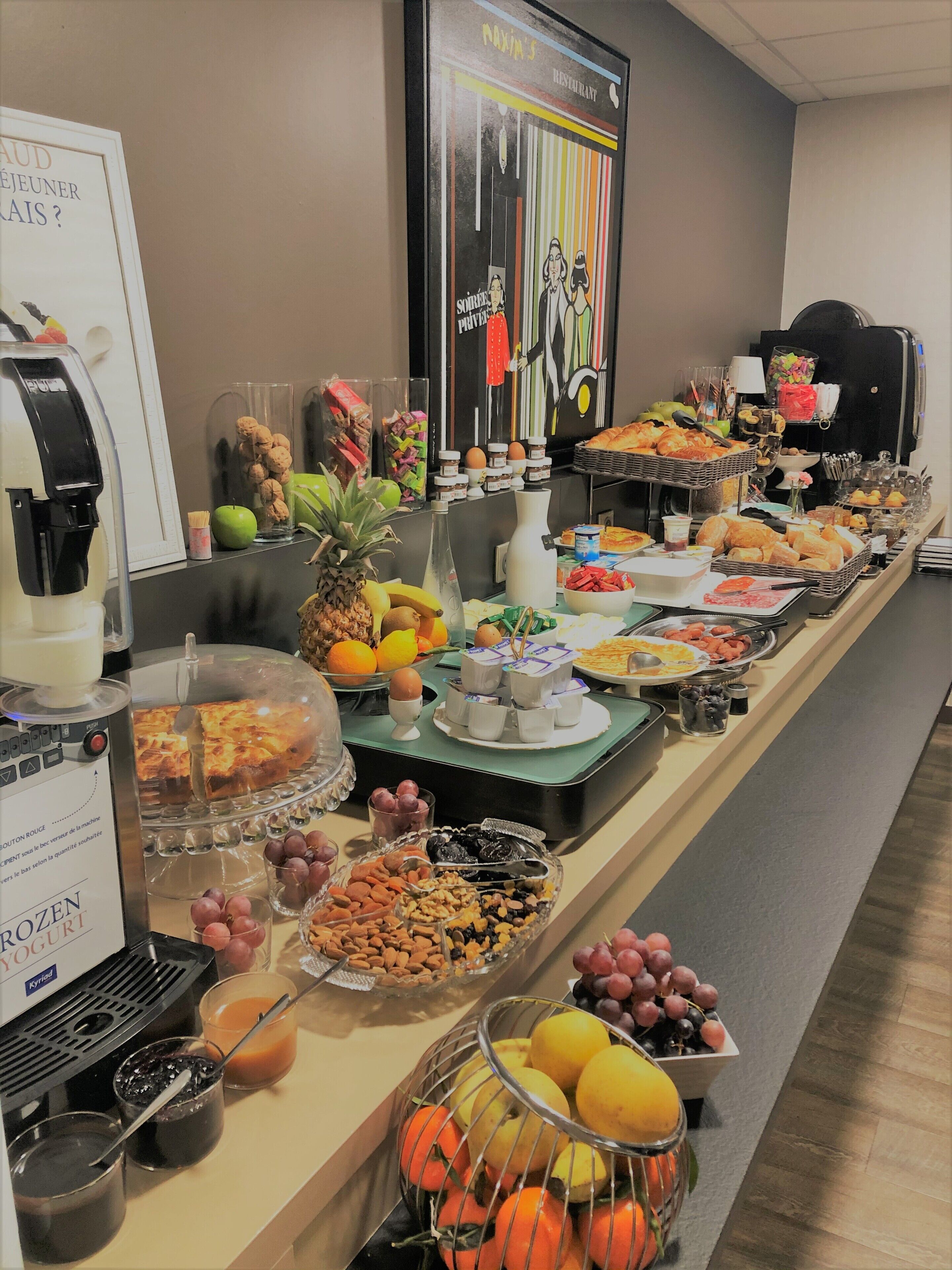 A buffet with various food items and a coffee machine.