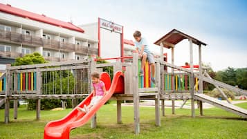 Ein Spielplatz mit Rutschen und Klettergerüsten.