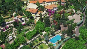 An aerial view of a large estate with multiple buildings, a swimming pool, and extensive landscaping. - Park Hotel Ville Montefiori (Gardone Riviera)