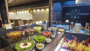 A buffet area with various food options, including salads, dips, and a grill station. - MenDan Magic Spa & Wellness Hotel (Zalakaros)