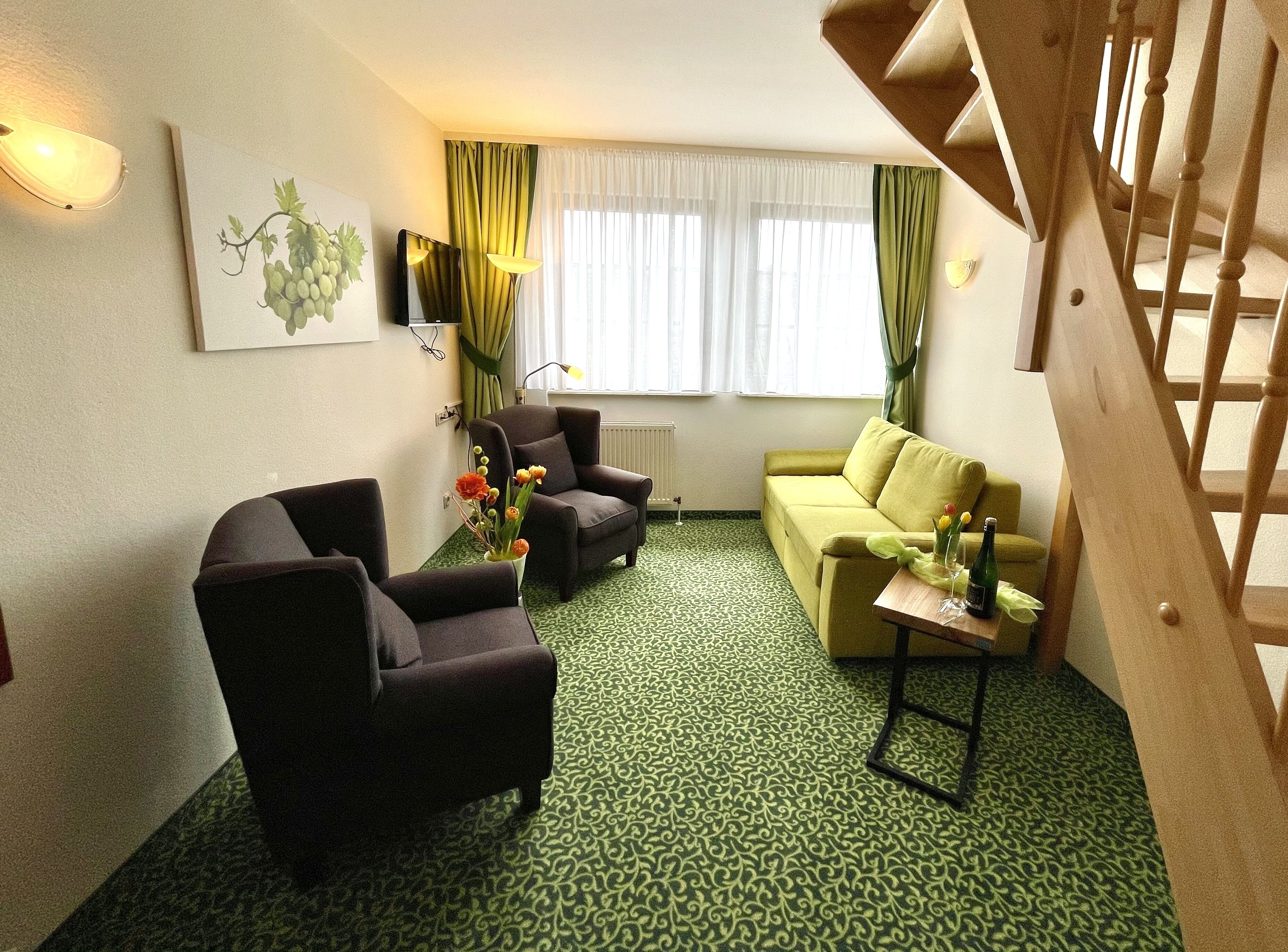 family quadruple room | living area | flat-screen tv