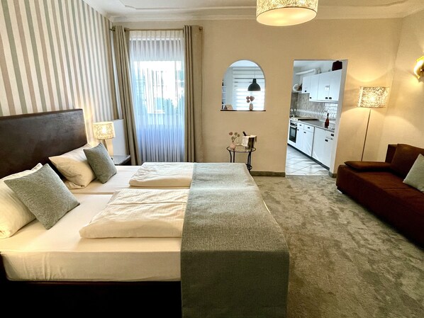 Down duvets, pillow-top beds, in-room safe, desk